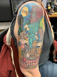 a woman's arm with a tattoo of a woman and a cat