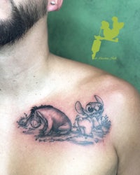 a man with a disney tattoo on his chest