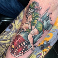 a tattoo of a woman riding a rocket