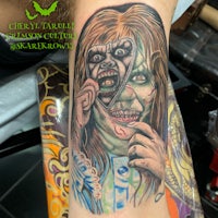 a tattoo of a woman with a zombie face on her arm